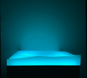 Alex Weinstein, "swell model (lite ’n space case)," 2023, cast polyester resin, wood, oil paint, LED lighting system, wireless USB charger)